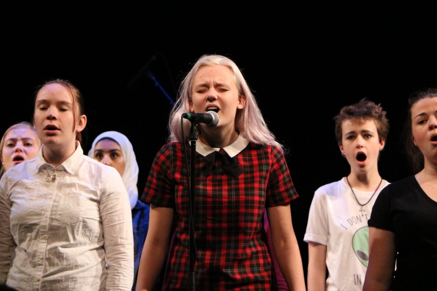 Junior Emily Schoonover sings her solo in "City Called Heaven".