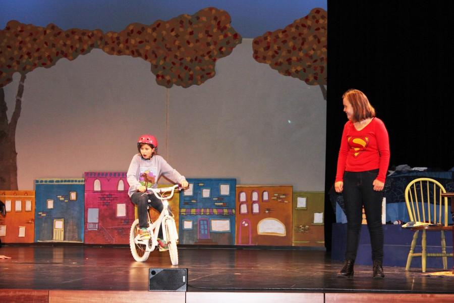 Sixth grader Isabella Tunney (Debbie Fine) pedals to save her family and stop robbers, while seventh grader Maren Ostrem, Debbie’s older self, narrates the adventurous story of Dizzy Fantastic. “When Debbie learns that she can fly on her bicycle, she feels empowered to become Dizzy Fantastic, super hero!” Hueller said.