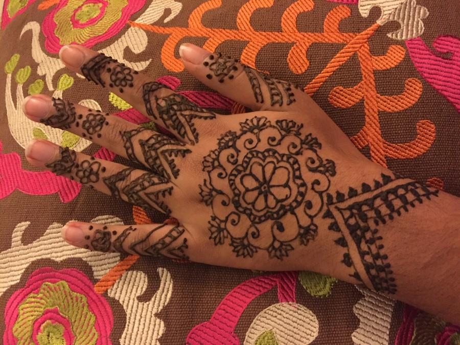 This hand models a henna design drawn by junior Tabeer Naqvis mother.  Henna makes me happy because it is a part of my culture and symbolizes joy, Tabeer said.