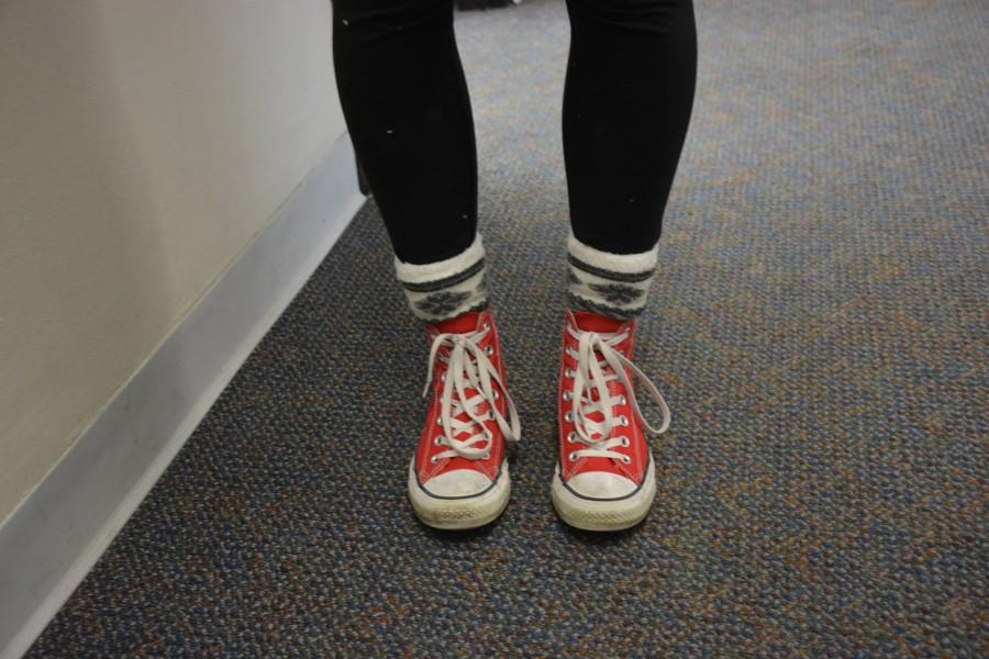 Freshman Adelia Bergner wears bright red Converse.   I like wearing shoes with colors that match my outfit, but sometimes I go for bold ones that make an outfit stand out, Bergner said.