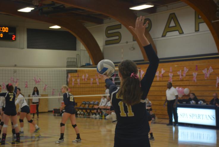 Freshman Blythe Rients prepares to serve 