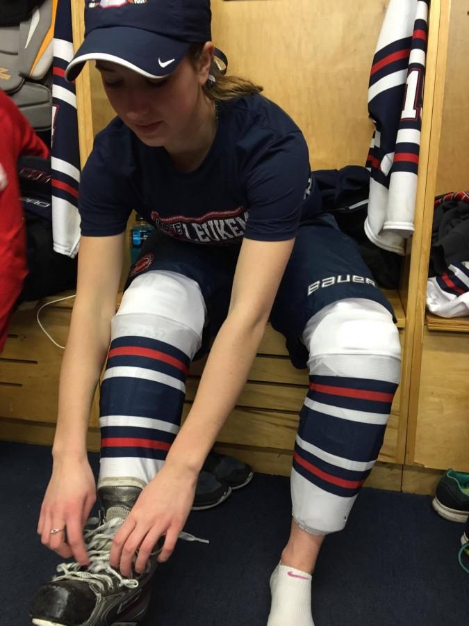 Senior captain Bridget Hoffman prepares for the game against Breck wearing her Lace Up for Leukemia gear. We have been planning for this all year, she said.