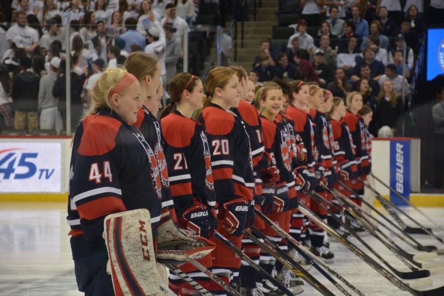 United players wait for Warroad to finish their player introductions.