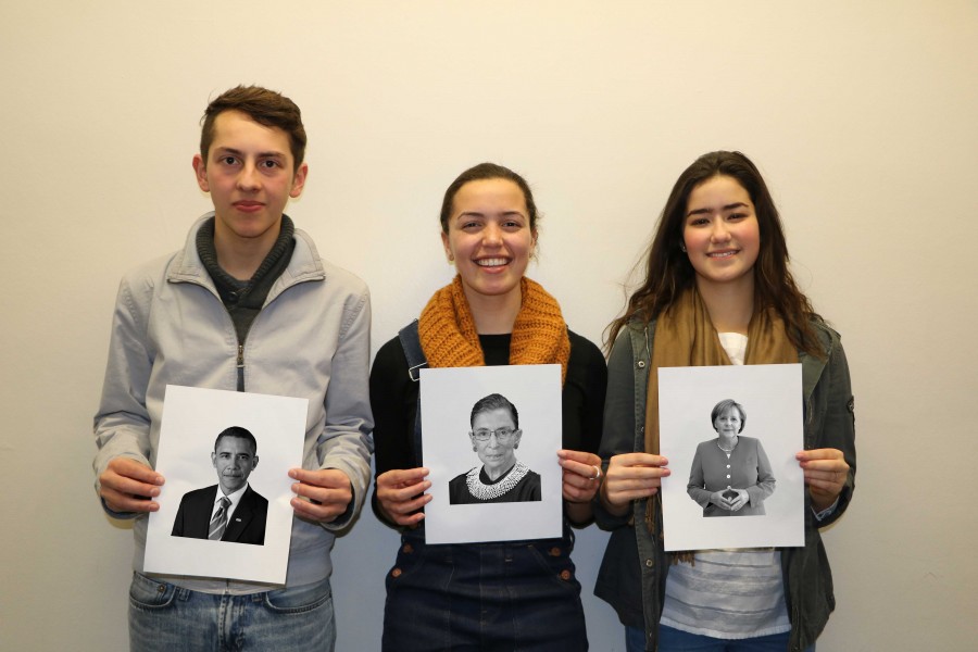 SENIOR GEORGE STIFFMAN, JUNIOR KATHRYN SCHMECHEL, AND SOPHOMORE NUMI KATZ pose for a photo, each holding up a portrait of a great leader whose traits they emulate in their style of leadership. Portraits include, from right to left, President Obama, Justice Ruth Bader Ginsburg, and Chancellor of Germany Angela Merkel. “Being a leader, you just need to make decisions. You either do something or you don’t,” Stiffman said.