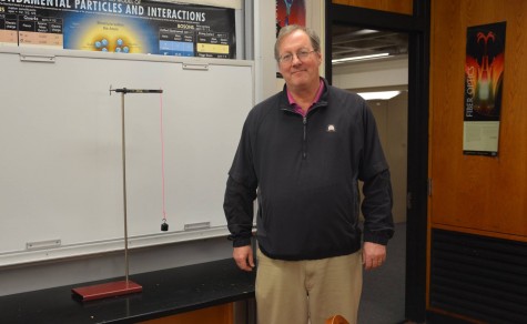 Jim Tisel stands by a pendulum, the apparatus Tisel used to study the power of questions in the classroom.. “A driving motivation for me as an educator has been ‘what motivates students to ask questions’,” Tisel said.