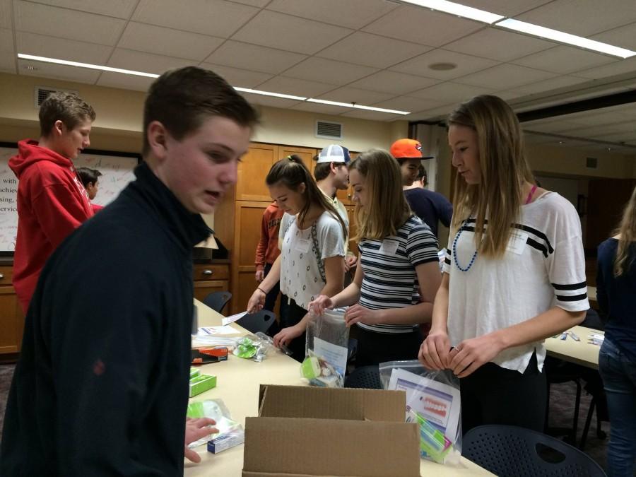 SPA students pack dental hygiene kits containing floss, toothpaste, and more at Project for Pride in Living, one of the nonprofit organizations that that students volunteered at during Service Day. 