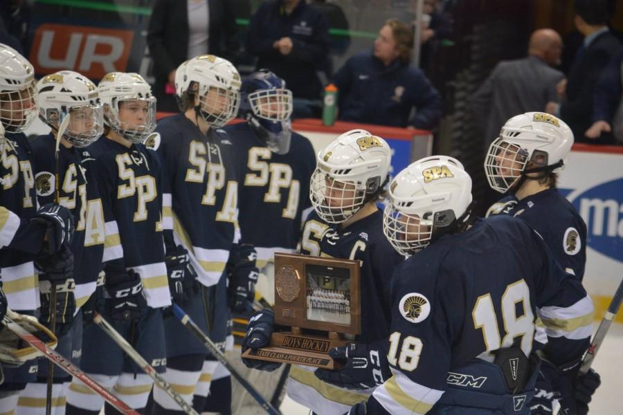 Senior captains Justin Jallen, Evan Dahlseide, and Cullen McCabe accept the fourth place trophy in the Spartans first trip to the MSHSL state tournament.