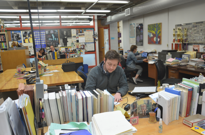 UPPER SCHOOL MATHEMATICS TEACHER CARL CORCORAN works at his desk in the math wing. “It was a really good place for me to learn and develop as a teacher,” Corcoran said.