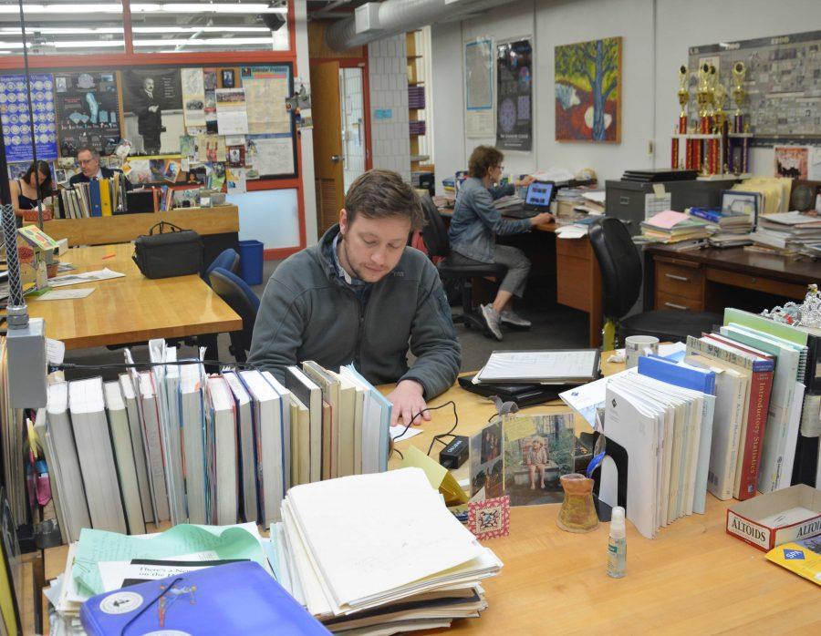 Upper School Mathematics teacher Carl Corcoran works at his desk in the math wing. It [SPA] was a really good place for me to learn and develop as a teacher, Corcoran said.