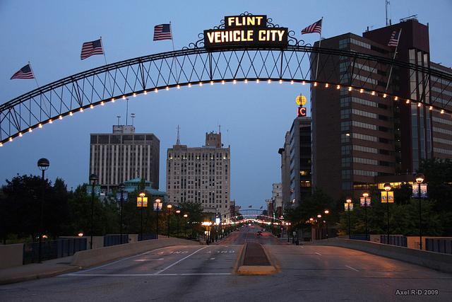Flint Michigan's signs of prosperity from the vehicle city days shed a vaneer on the socioeconic problems that plague the city and have led to unhealthy water.