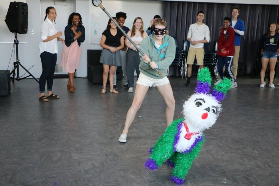 Sophomore Elsa Runquist smashes the piñata at the Cinco de Mayo celebration on May 4. We explained some history about Cinco de Mayo, but mostly we just wanted people to learn about the culture,” sophomore Eva Garcia said.