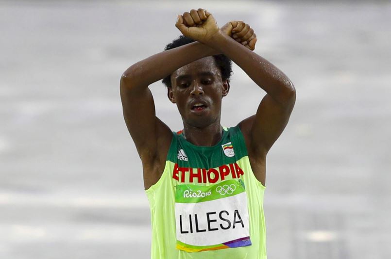 Olympic silver medalist, Ethiopian Feyisa Lilesa crossed the finish line with his arms above his head in the shape of an "X." He was protesting his government's persecution of the Oromo people.
