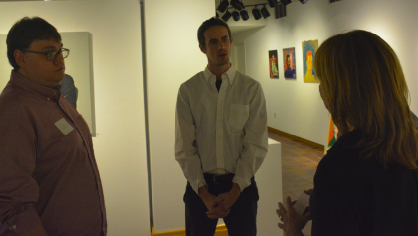 Dowdle and Smith talk to their former art teacher Joy Liberman at the opening show.