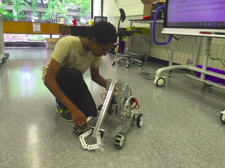 Sophomore Imran Umer works on a robot in the new computer science classroom. "I have been into robotics ever since I was young and I like to make things out of other things and see what happens," Umer said. 