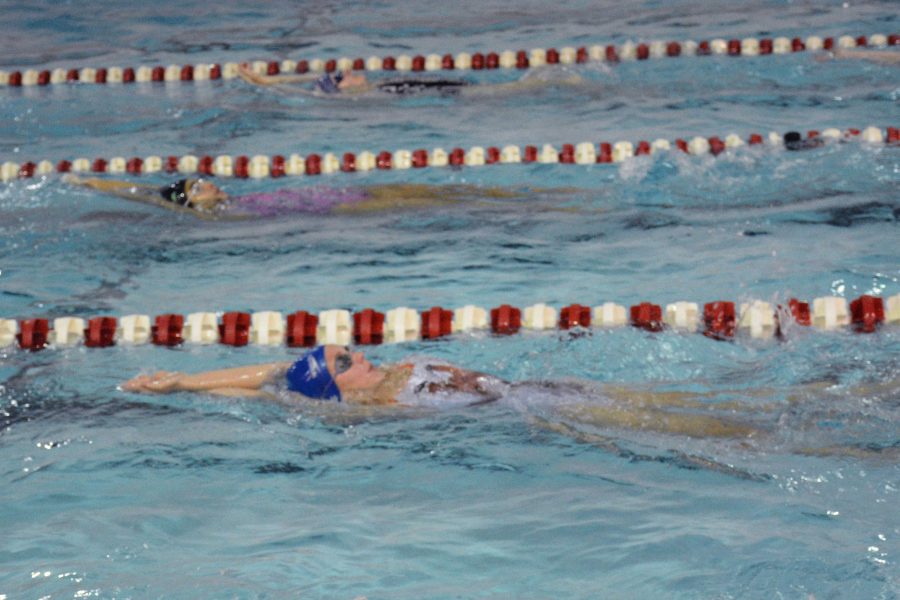 PADDLE AND KICK. Freshman Lauren Dieprink swims laps at Highland Highschool.
