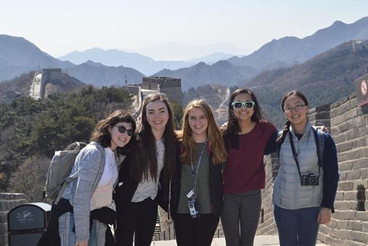 Juniors Mira Zelle and, Allie Verhey, sophomore Gabby Harmoning, and juniors Julia Wang and Sky Li Griffiths pose during a walk on that Great Wall of China during their exchange visit to China over Spring Break. 
