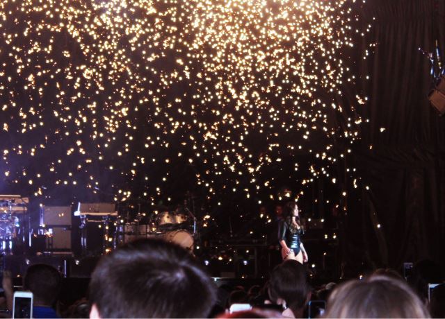 Demi Lovato enters the stage while her new hit song Confident begins to play.