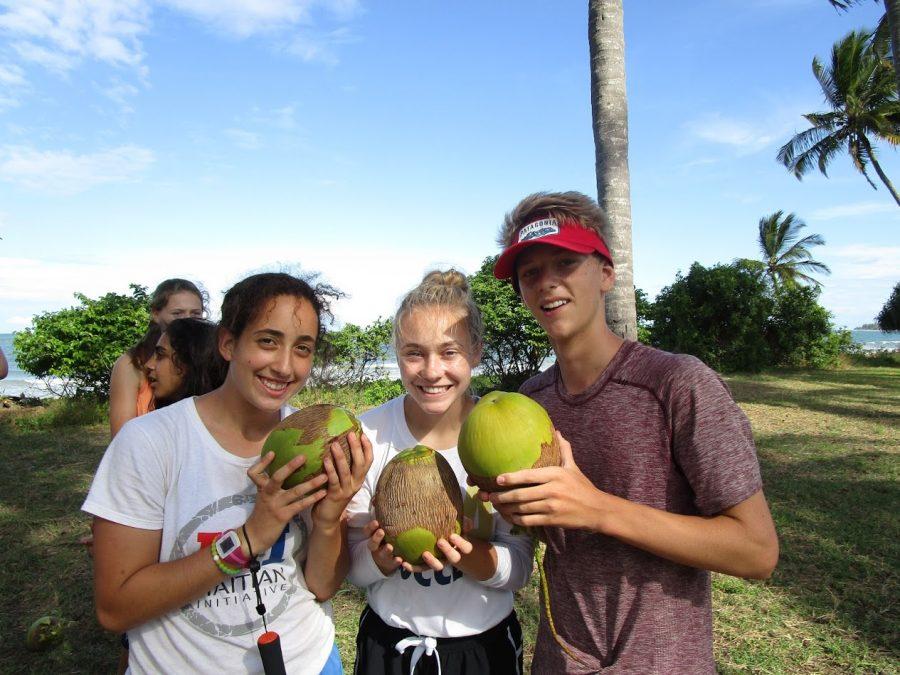 PARADISE+FOUND.+Juniors+Dina+Moradian+%28left%29%2C+Erin+McNamer+%28middle%29+and+Robin+Bartlett+pose+for+a+photo+with+coconuts+during+the+15-day+trip+in+Tanzania