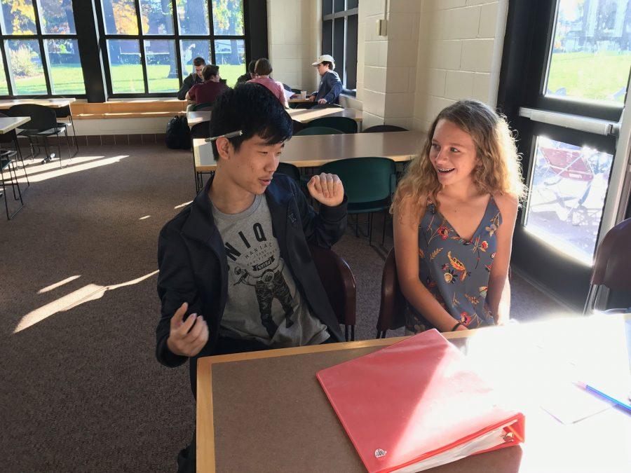 SOCIALIZING. Allan Wang chats with sophomore Muriel Lang. “The study hall, I find that long period where you do your homework and finish it all, feels really good. In China, we have to finish all of our homework at home,” Wang said. 