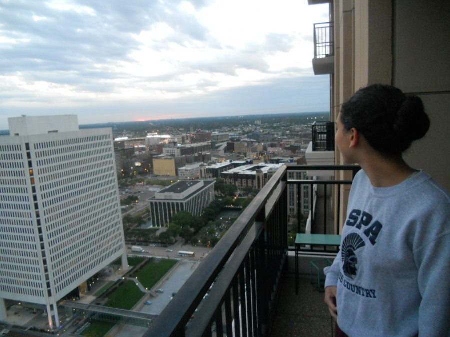 NEW PERSPECTIVES. Senior Neeti Kulkarni enjoys the view from her balcony in downtown Minneapolis.  “There’s not a feeling like it. You go out and you feel … I wouldn’t say you feel powerful because it is really freaky to look down on how many people are there … but it kinda gives you perspective on what’s out there and it’s just a really surreal feeling to be able to see the entire downtown laid out straight in front of you, Kulkarni said.