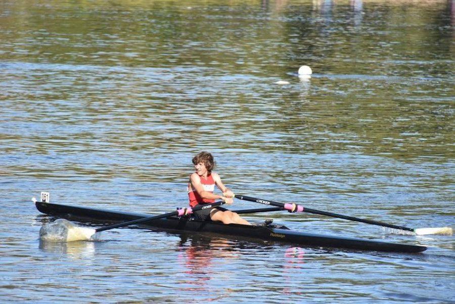 BATTLING THE MISSISSIPPI. Junior Henry Zietlow rows across the Mississippi at a regatta. He has been rowing for one year “[Rowing] gives me a reason to get outside on the river every day. It’s really a pretty part of St. Paul, especially in the fall with all the changing colors,” Zietlow said.