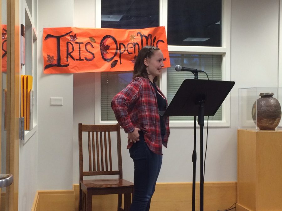 Ninth grader Anna Snider recites a piece she wrote in the Summit Center during Iris: Art and Literatures first open mic night hosted on Oct. 26. “I’m really glad that I did it,” said Snider.