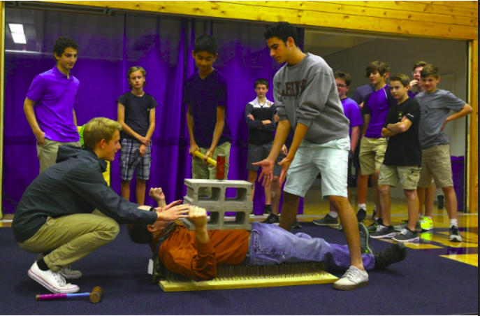 Advisor Steve Heileg lays on a bed of nails during the annual clubs fair on Sept. 15th.