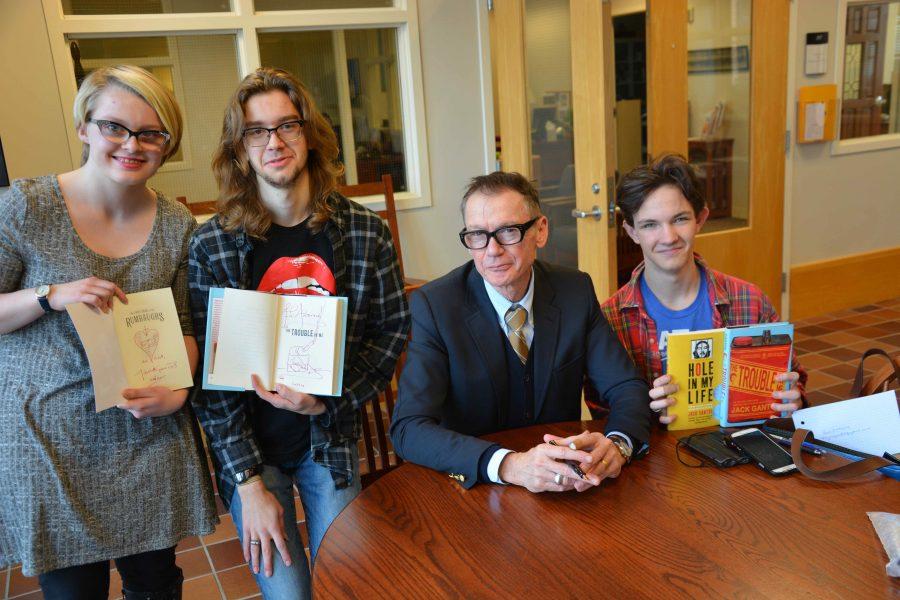 Author Jack Gantos signs books for seniors Ellie Brass, Andrew Michel, and sophomore Ben Atmore after speaking to Upper School students. Of writing, he said, "It was the hardest task I could think of which would be a challenge every day for my entire writing life.” 