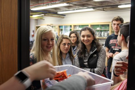 High school students participate in trick-or-treating during advisory