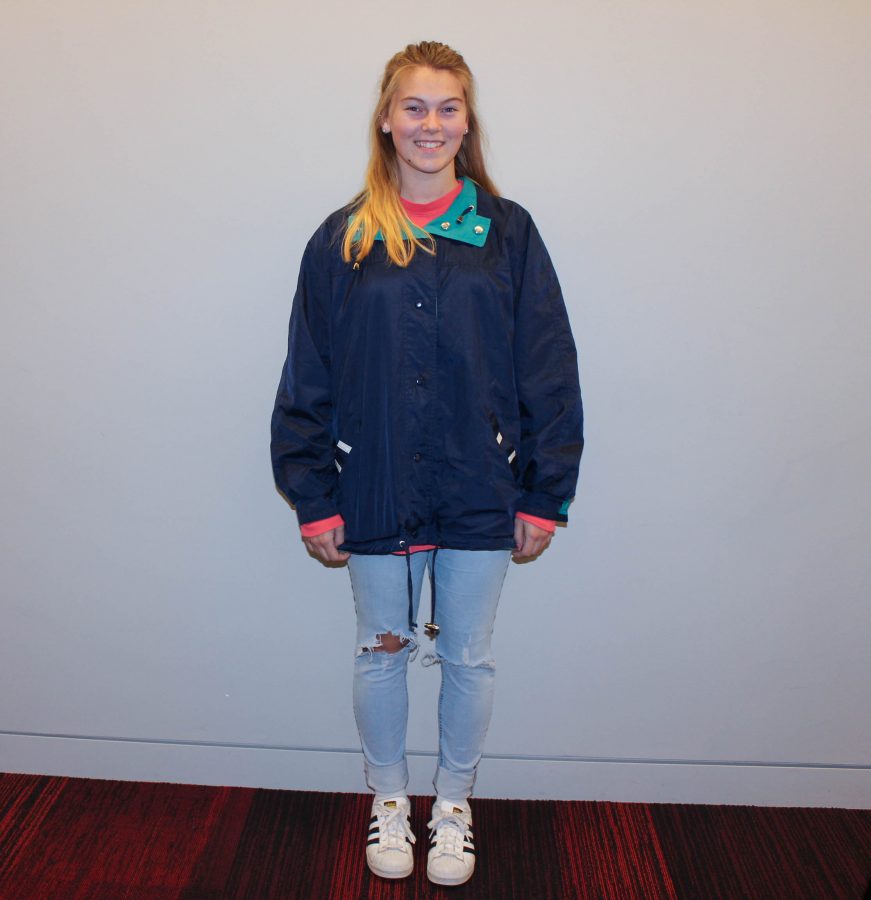 Senior Raegan Small poses in a vintage bomber and distressed jeans. "I got this jacket from the thrift store Unique," Small said.