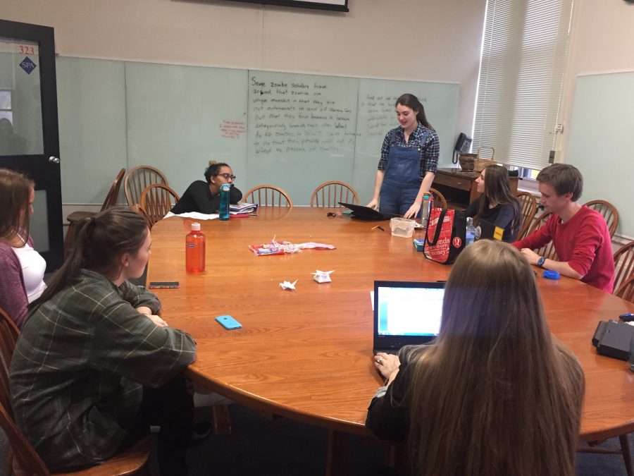 Senior Mary Grant practices reading one of her chosen poems aloud in front of the group.