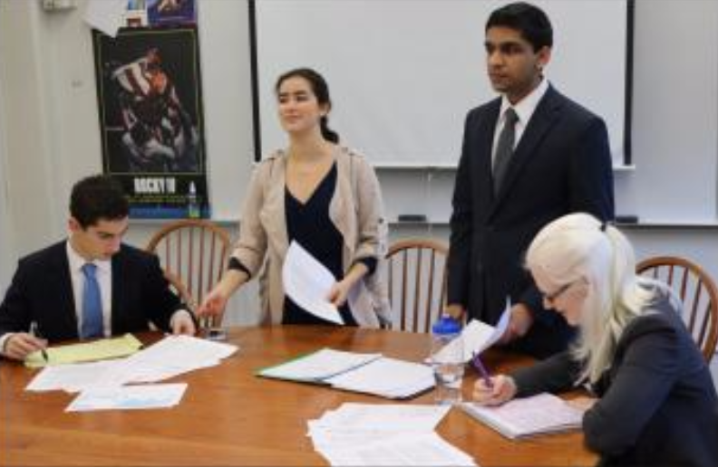 Juniors Ben Konstan, Numi Katz and Adnan Askari, along with senior Sarah Wheaton practice cross fire before the National Qualifiers on Dec. 10.