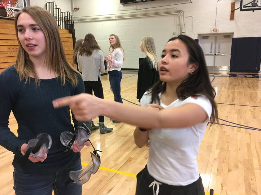 Seniors Oona Prozinski and Justine Miller facilitate SADD's drunk goggles competition.