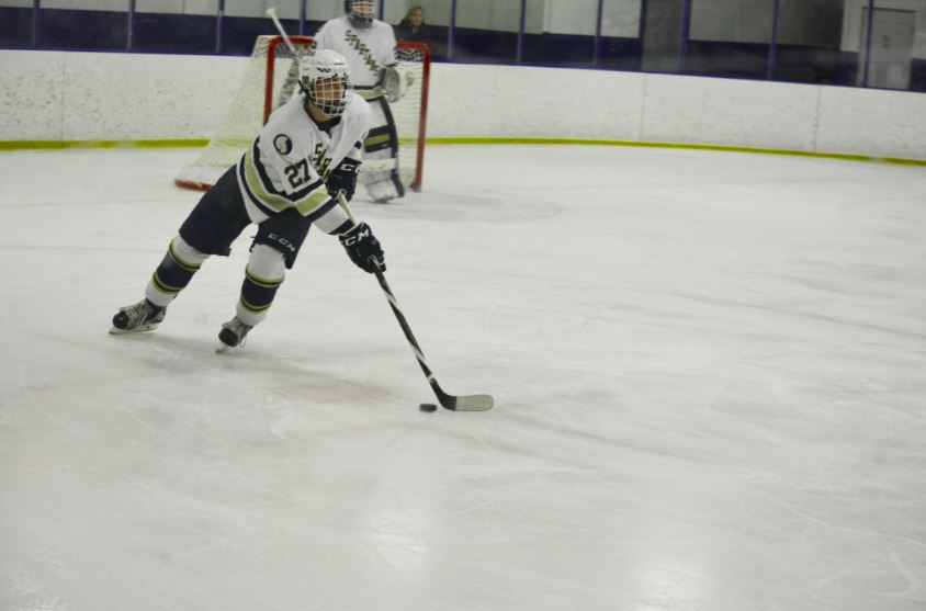 Senior defender Noel Parker carries the puck up the ice. 