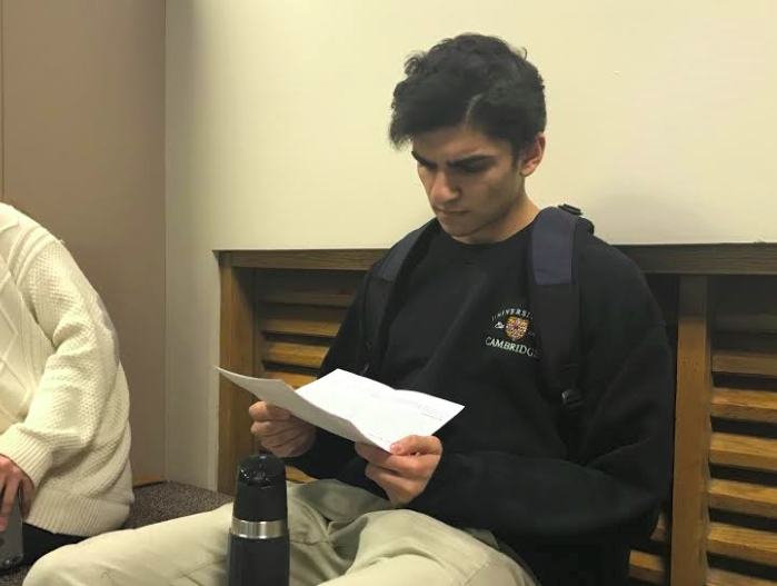 Senior Muneil Rizvi reads the narrative comments that he recieved from his teachers following the first semester. They are helpful for the students mostly because they help to improve organization and other things the teachers feel are important for the student, Rizvi said. 