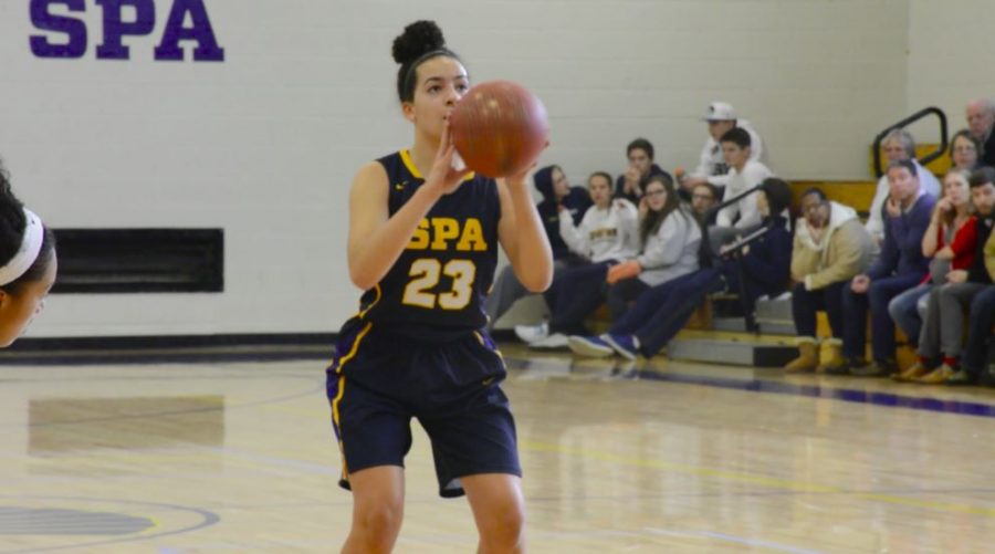 Junior Izzy Denny shoots a basketball at the Dec. 20 game against Nova Classical Academy. “I haven’t seen as many concussions in basketball as I have heard about for soccer or other sports like that,” Denny said. 