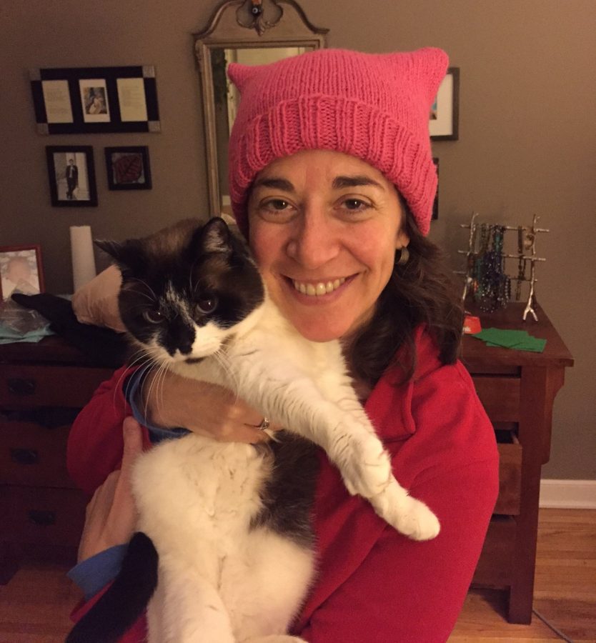 Assistant Director of College Counseling Andrea Sachs poses with her cat and her pussyhat that she knit herself as a part of the Pussyhat Project. “I did it [the Pussyhat Project] because it combines two of my favorite things: knitting and speaking up for women’s rights, so it was a natural thing for me to do,” Sachs said. 