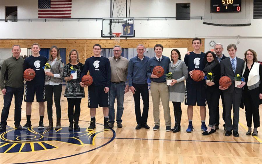 Class of 2017 Spartan boys basketball players stand with their parents before the game: Sam Dicke, Mark Ademite, Emerson Egly, Matthew Jaeger, and manager Jackson Jewett