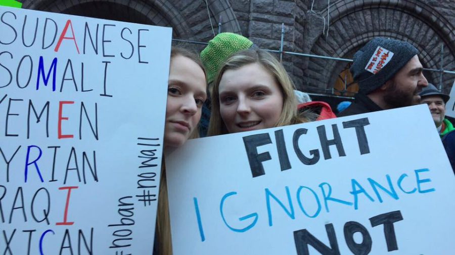 Seniors Ella Matticks and Emily Thissen attend a protest against Trump's first Executive Order prohibiting entry from seven countries into the U.S.  The order was later deemed Unconstiutional.