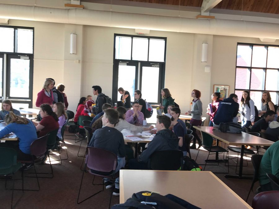 Advisories walk into the cafeteria with snacks, ready to design feminist stickers.