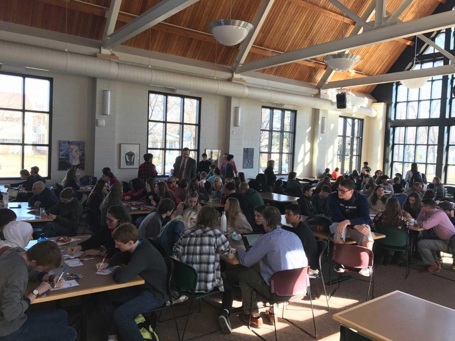 The cafeteria fills with people designing stickers. "I like that everyone came here to support women," senior Cara Pomerantz said.