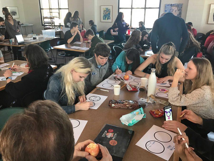 Mr. McVeety's advisory all works on their stickers. "[The contest] is a way to give women the respect that they deserve," said sophomore Imran Umer.