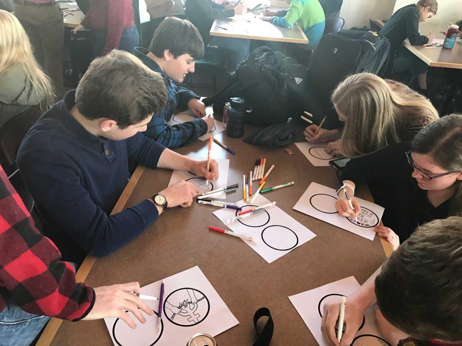 Sophomores Kelby Wittenberg, Ethan Asis, Maggie Hlavka, and Lily Nestor all work intently on their stickers. 