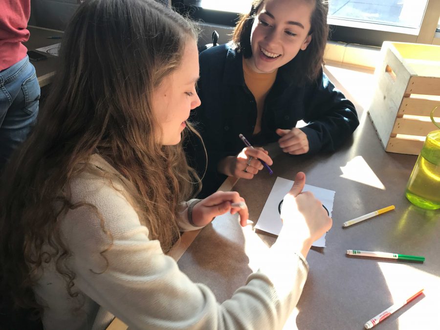 Sophomores Nora Povejsil and Izzy Dieperink collaborate on a sticker design.