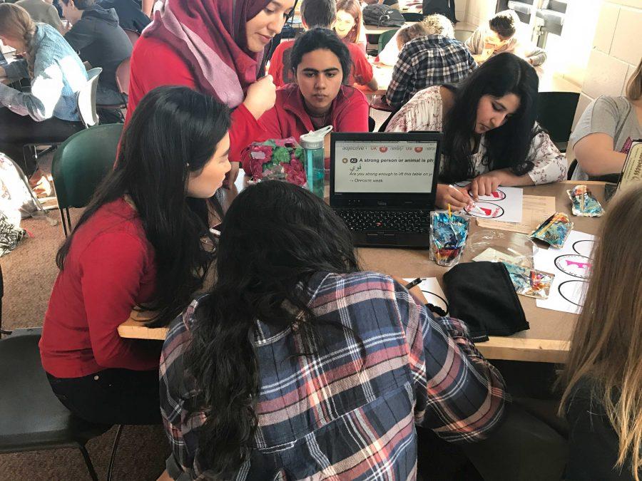 Seniors Amodhya Samarakoon, Stephanie Li, Noor Quiereshy, Sarah Murad, and Tabeer Naqvi work on their feminist stickers.