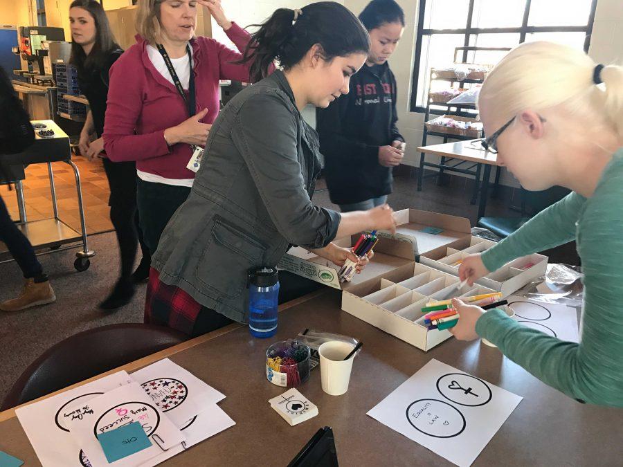 HerSpace co-president, junior Numi Katz,helps put away supplies while advisories leave. I think it went really well! We got  lot of people to come, and a lot of really cool stickers, said Katz.