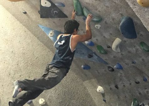 Junior Zach White swings on to the wall as he climbs up.  I am hoping to make it to nationals, I have been super close before. At divisionals, it’s a two day event, and both times I’ve placed at divisionals, I have placed 11th, White said. 