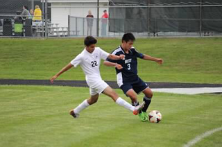 Sophomore Husaam Qureishy tackles another player for the ball. 