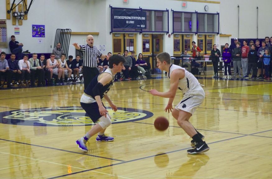 Senior Tommy Dicke dribbles around a defender at the Mar. 9 section quarterfinals game vs. St. Croix Prep. 