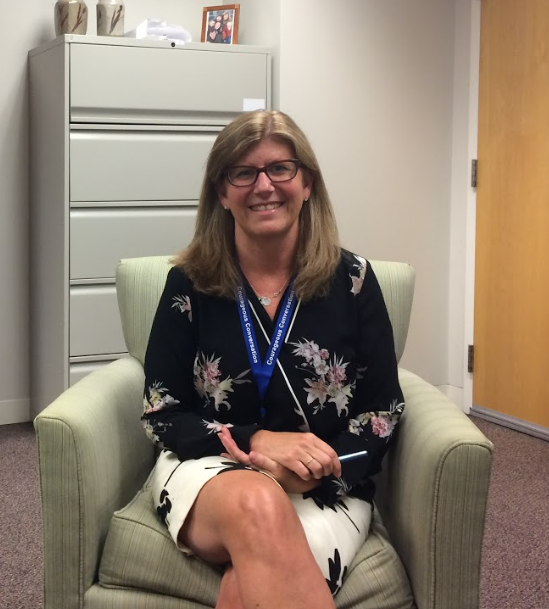 Jill Romans poses in her old office after discussing the new opportunities her new position will offer in the 2017-18 school year.